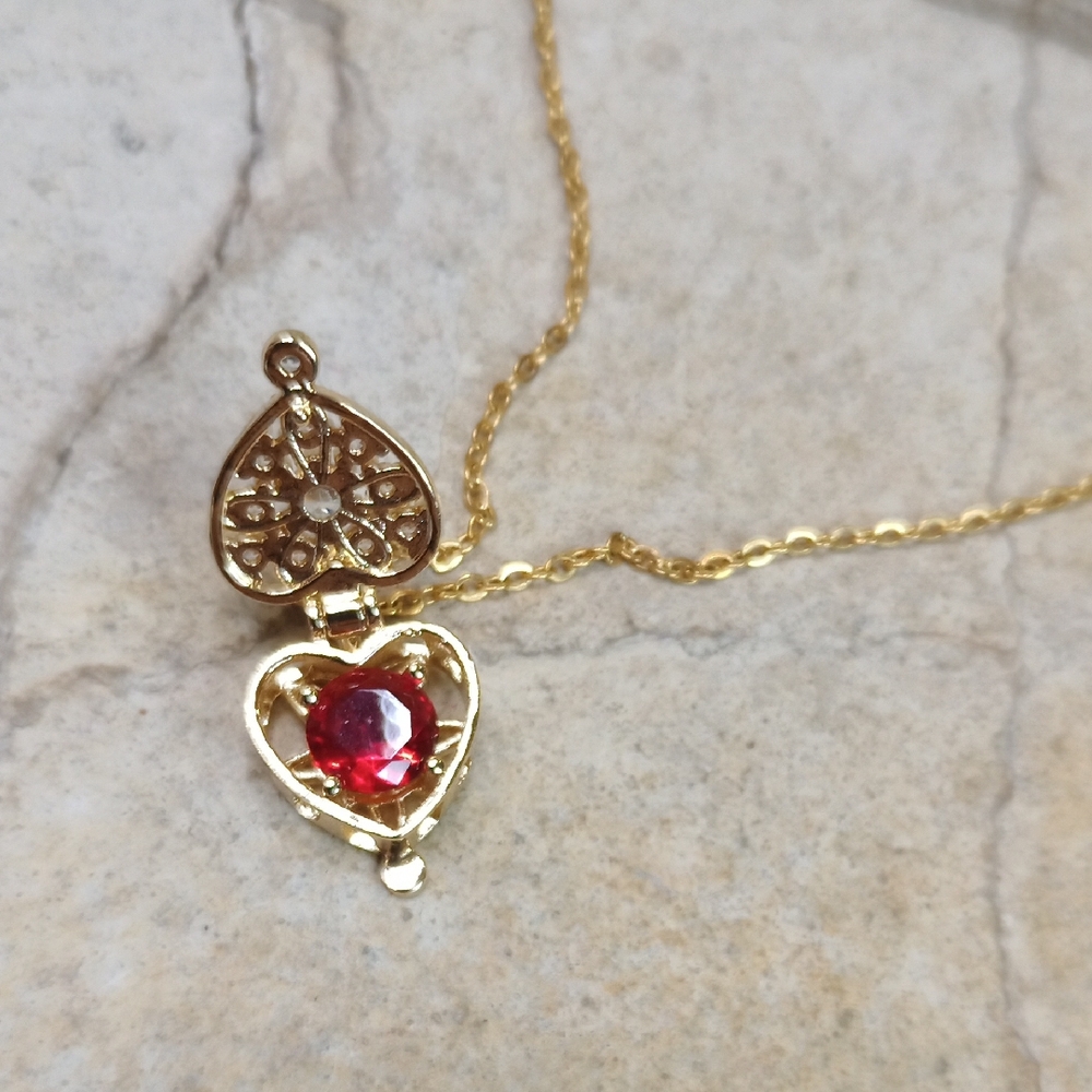 Elegant Gold Heart Pendant Necklace With Hidden Ruby Red Crystal